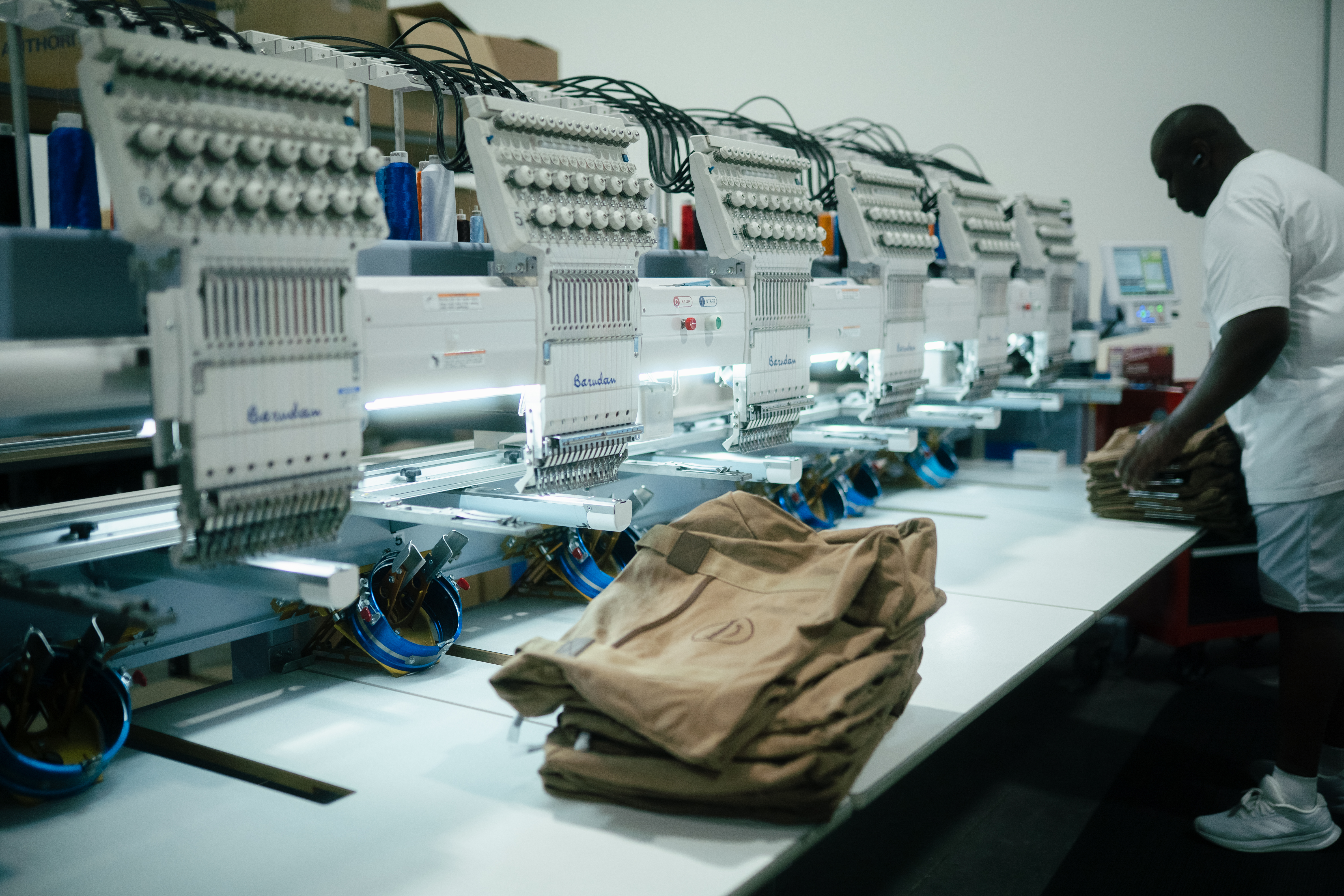 Barudan multi-head embroidery machine stitching custom hats in Naples, FL