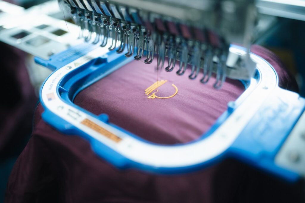 Garment hooped in a Barudan embroidery machine during a production run in Naples, FL